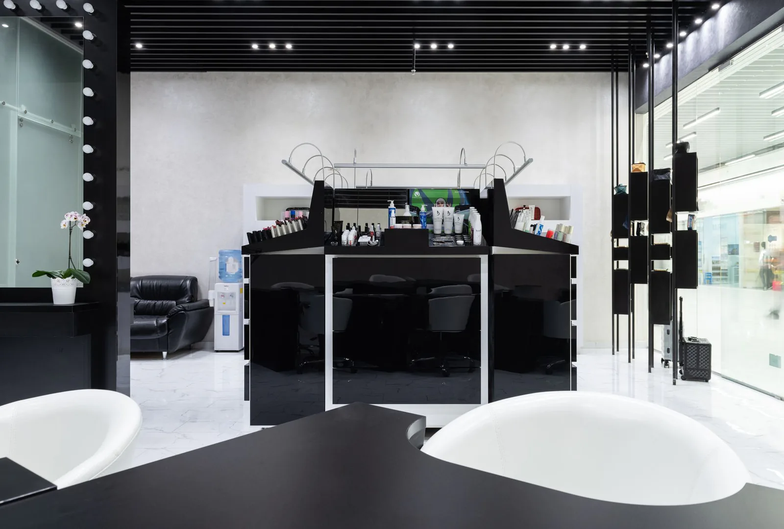 Chic salon with black and white decor and luxury styling stations