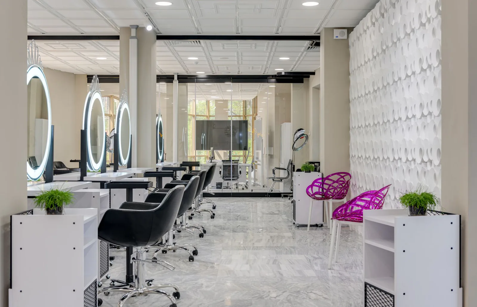 Chad Rookstool Salon interior with sleek styling chairs and illuminated mirrors