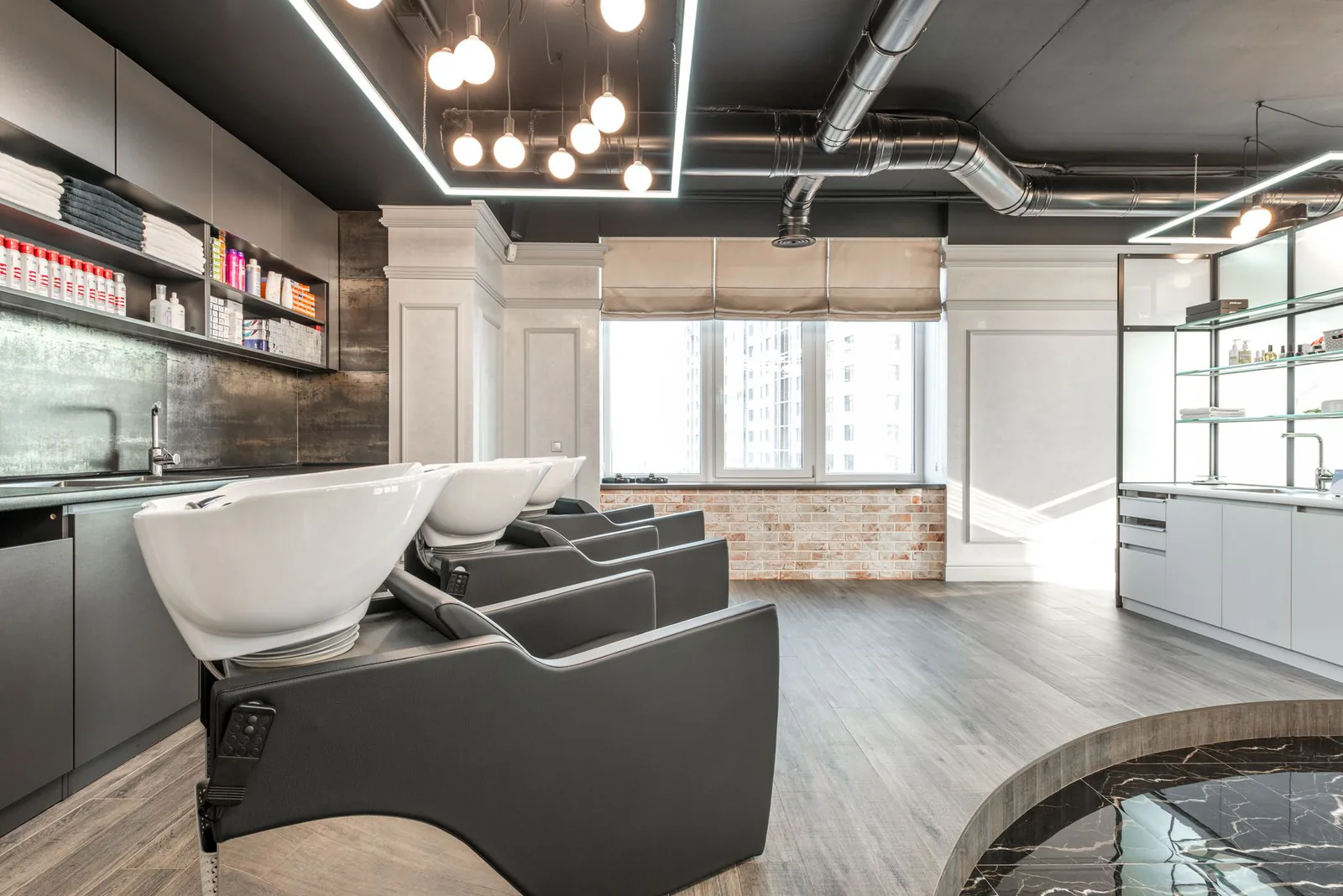 Salon wash station with modern chairs and styling products